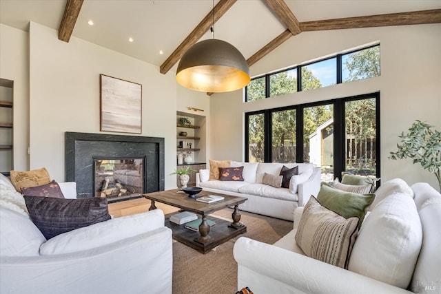 living room featuring beamed ceiling, built in shelves, and high vaulted ceiling