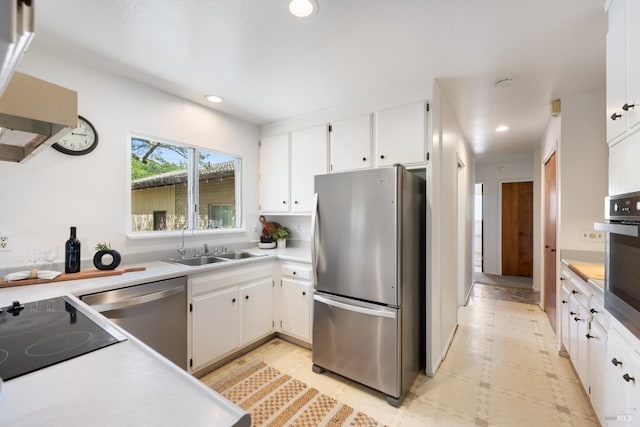 kitchen with sink, white cabinets, and appliances with stainless steel finishes