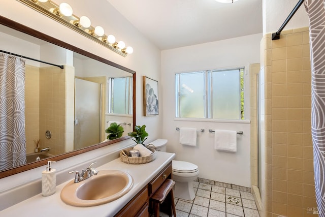 full bathroom with tile patterned flooring, vanity, toilet, and tiled shower / bath combo