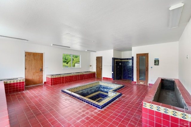 view of pool featuring an indoor hot tub