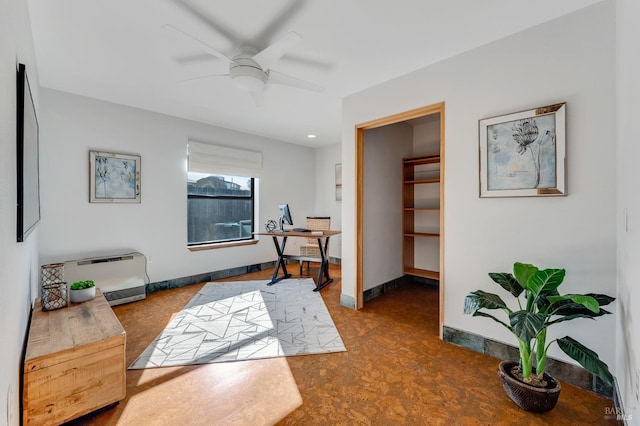 interior space with baseboards and a ceiling fan