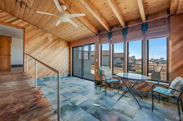 unfurnished sunroom featuring wooden ceiling, beam ceiling, and ceiling fan