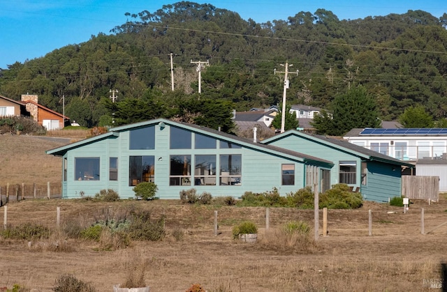 back of house with fence