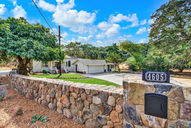 ranch-style house featuring a garage and a front yard