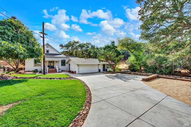 view of front of house with covered porch, a garage, and a front lawn