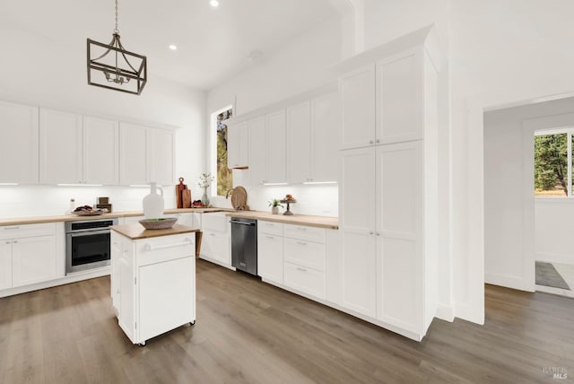 kitchen with white cabinets, stainless steel appliances, and hardwood / wood-style flooring