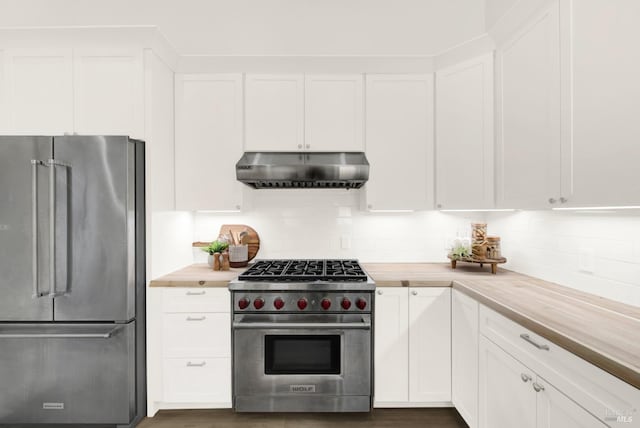 kitchen featuring appliances with stainless steel finishes, dark wood finished floors, under cabinet range hood, white cabinetry, and decorative backsplash