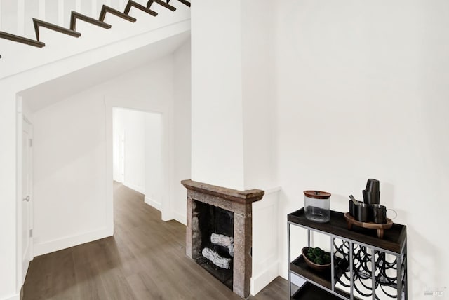 hallway with hardwood / wood-style flooring