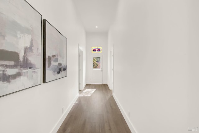 corridor with dark hardwood / wood-style flooring