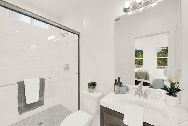 bathroom featuring vanity, toilet, and an enclosed shower