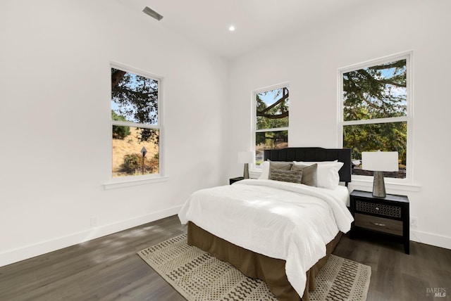 bedroom featuring dark wood-style flooring, visible vents, baseboards, and recessed lighting