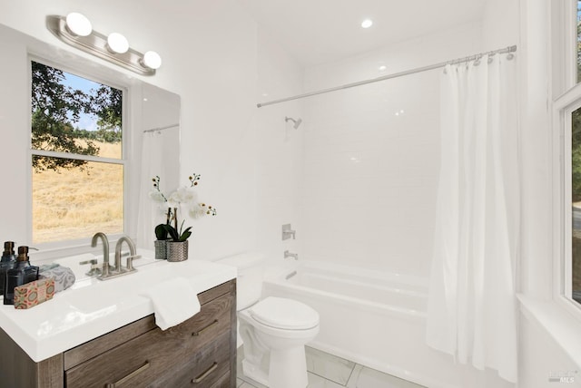 full bathroom featuring shower / tub combo with curtain, vanity, a healthy amount of sunlight, and toilet