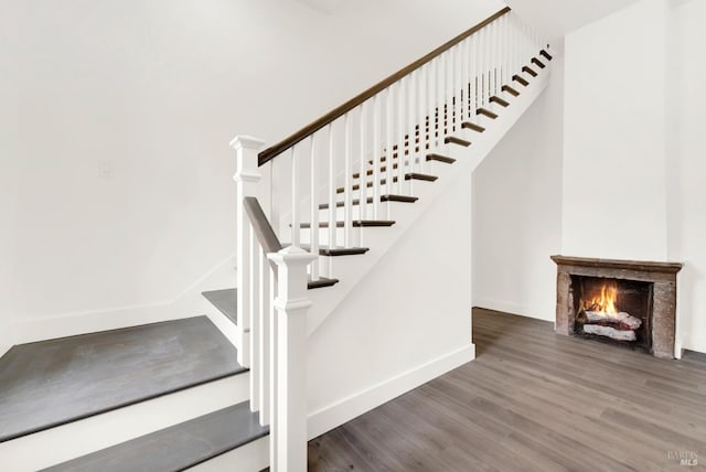 stairs featuring hardwood / wood-style flooring