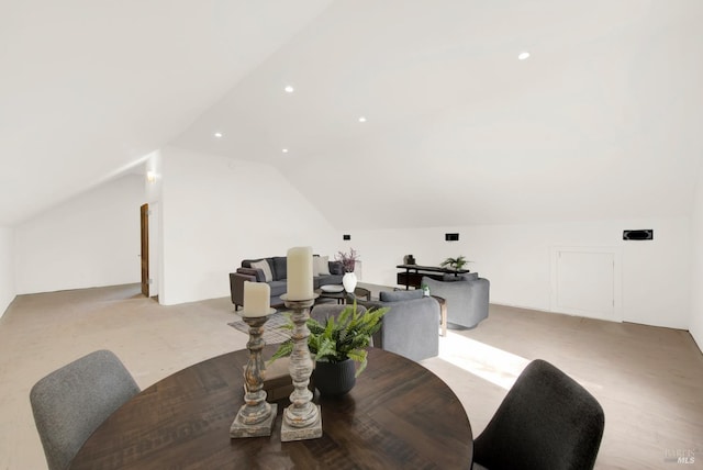 carpeted dining space featuring recessed lighting and vaulted ceiling