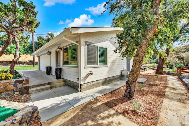 view of side of home featuring a garage