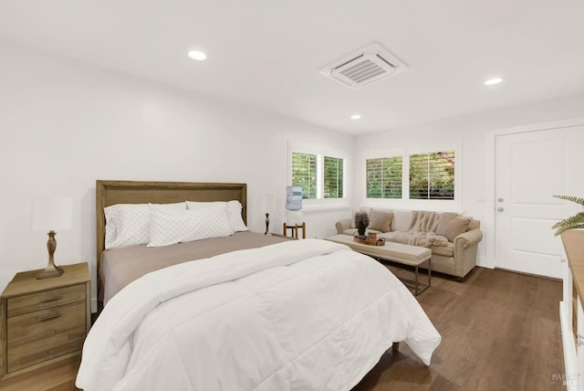 bedroom with dark wood finished floors, visible vents, and recessed lighting