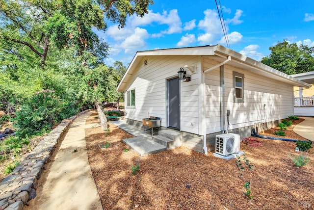 view of side of property with ac unit