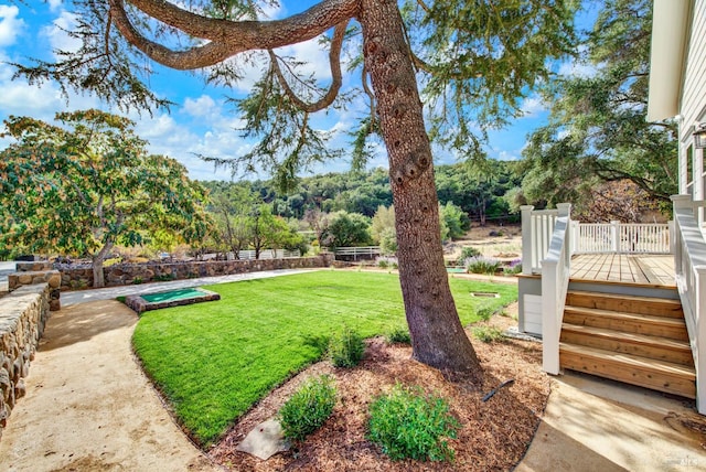 view of yard featuring a wooden deck