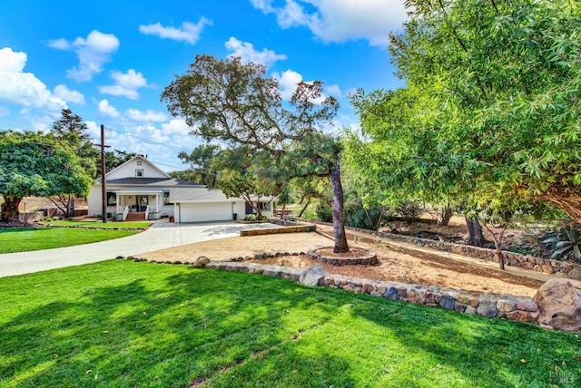 view of yard featuring a porch and a garage