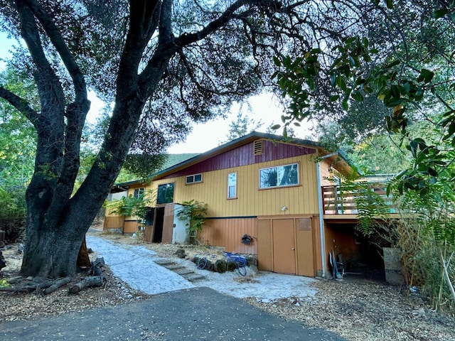 view of side of property with a wooden deck