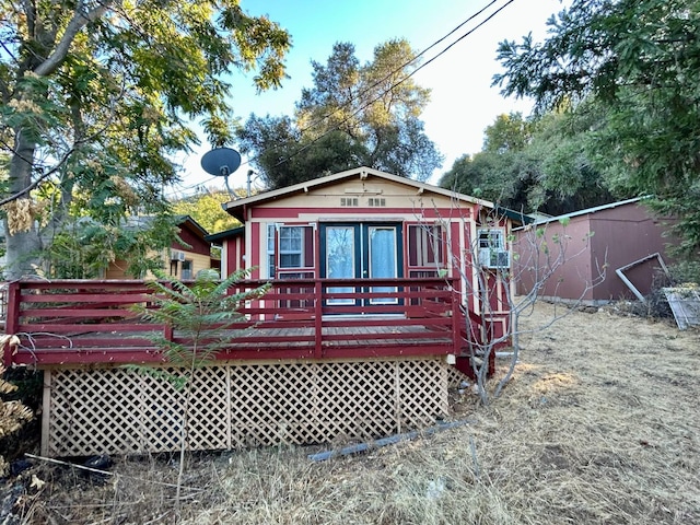 back of house with a wooden deck