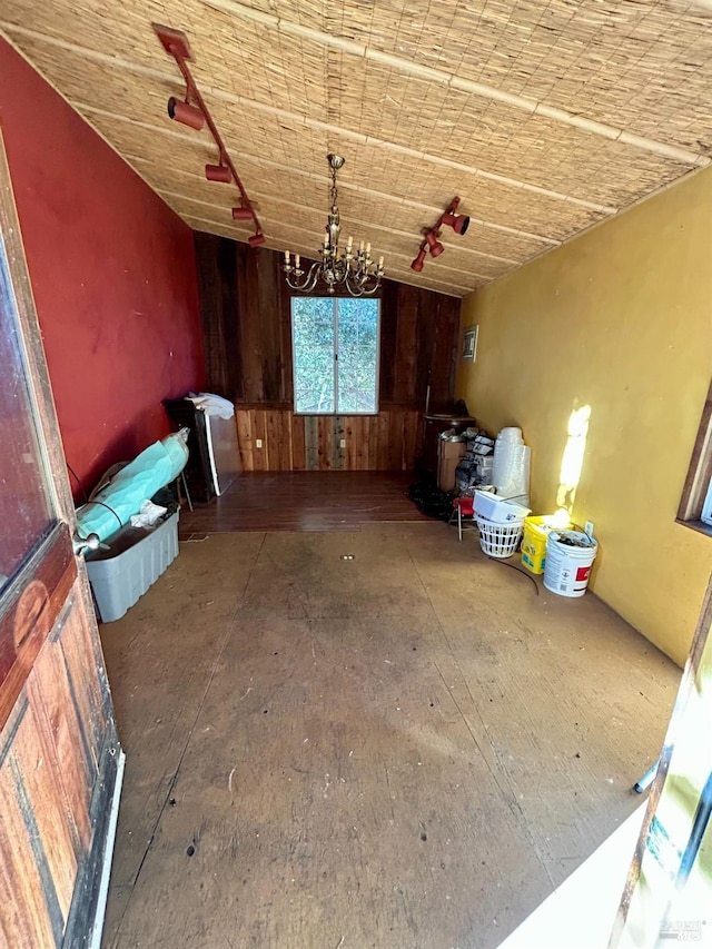 misc room with wooden walls and a chandelier