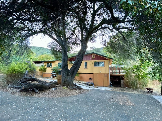 view of front of home featuring a deck with mountain view