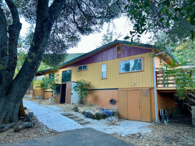 view of property exterior with a wooden deck