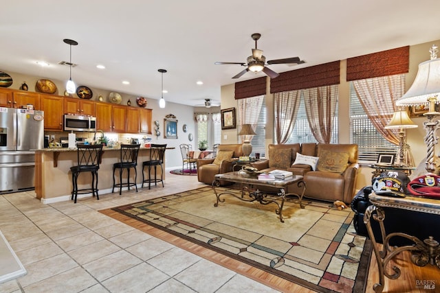 tiled living room featuring ceiling fan