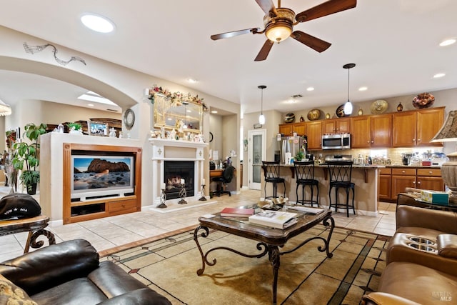 tiled living room with ceiling fan