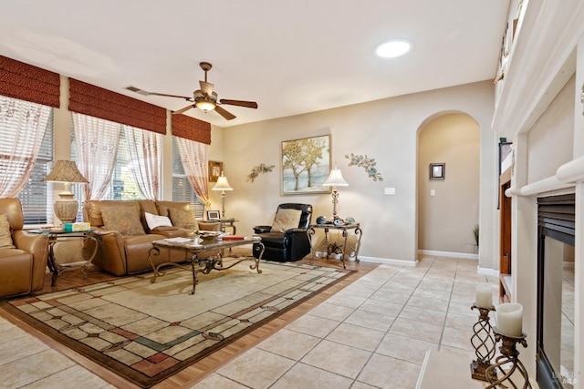 living room featuring ceiling fan and light tile patterned flooring