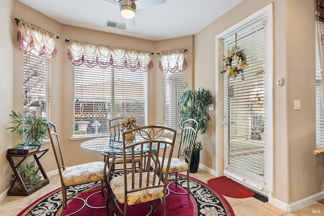 dining room with tile patterned flooring, visible vents, ceiling fan, and baseboards