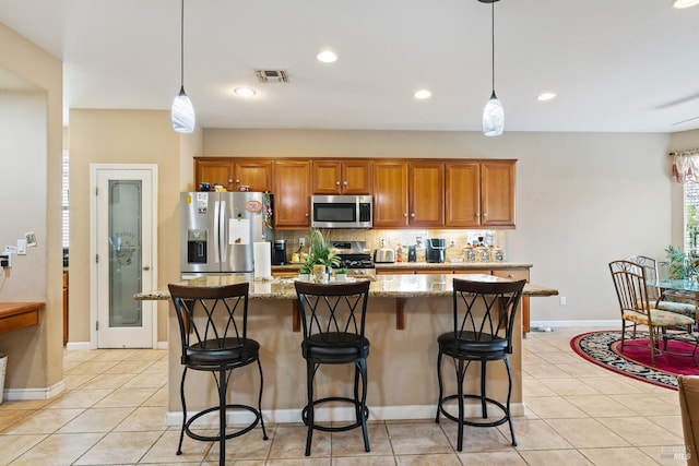 kitchen featuring stainless steel appliances, visible vents, backsplash, and light tile patterned floors