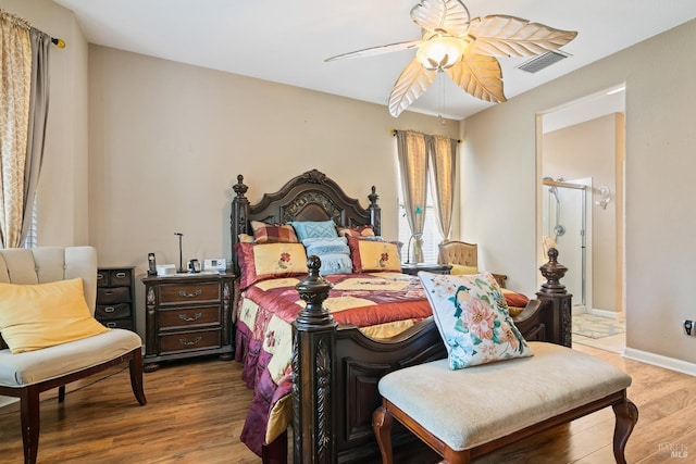 bedroom with baseboards, ceiling fan, visible vents, and wood finished floors