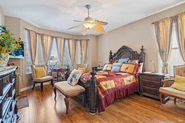 bedroom with light wood-style flooring and a ceiling fan