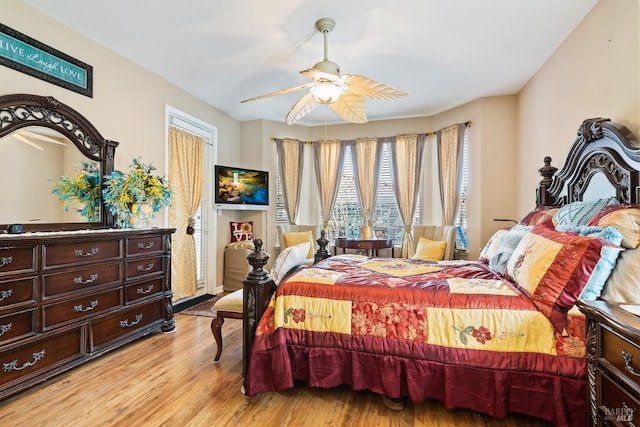 bedroom with ceiling fan and light wood-type flooring