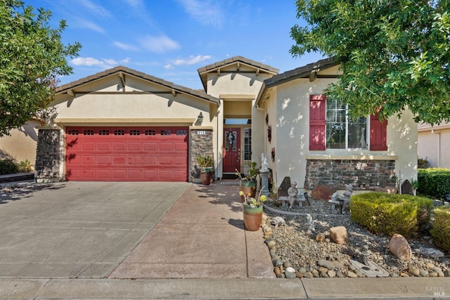 view of front of property with a garage, stone siding, concrete driveway, and stucco siding