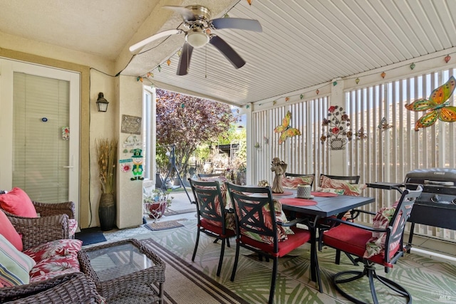 sunroom / solarium featuring ceiling fan, a wealth of natural light, and vaulted ceiling