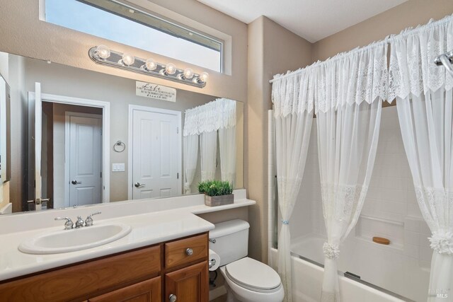 bathroom featuring shower / bath combination with curtain, vanity, and toilet