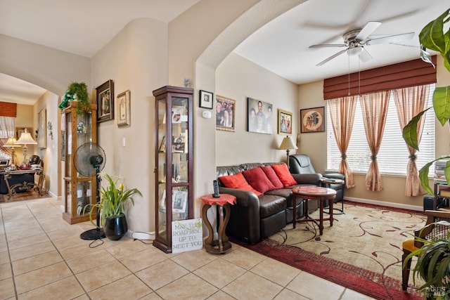 tiled living room featuring ceiling fan