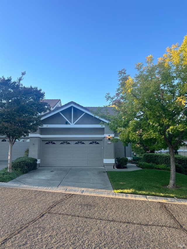 view of front of property with a garage and a front lawn