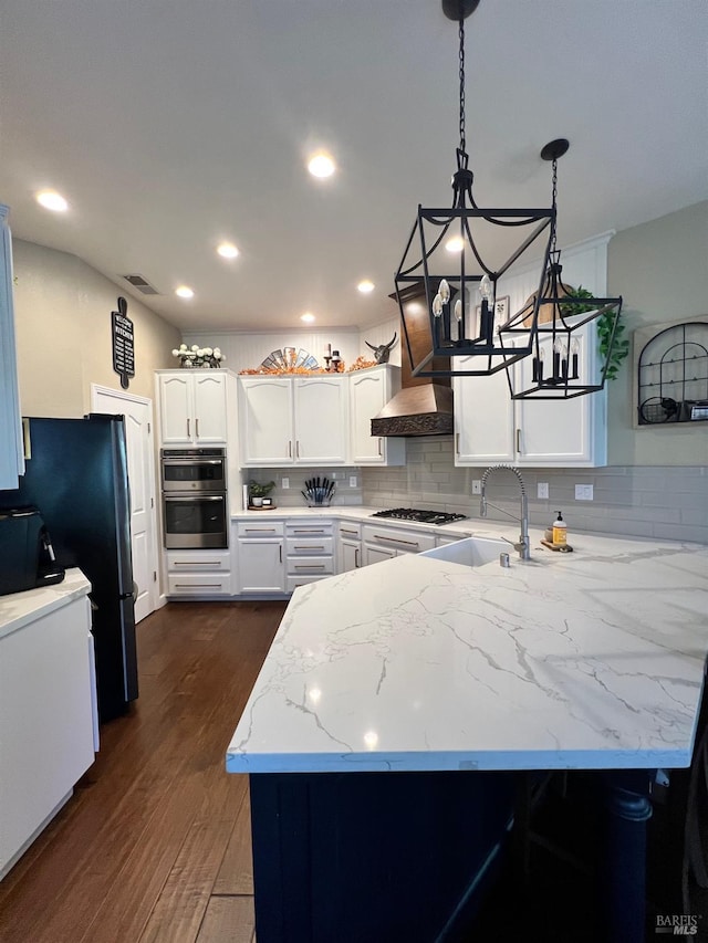 kitchen featuring white cabinetry, kitchen peninsula, hanging light fixtures, backsplash, and dark hardwood / wood-style flooring