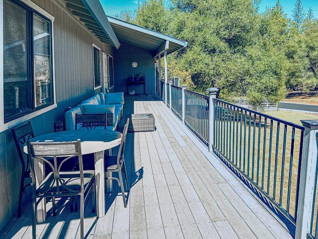 wooden deck featuring an outdoor living space