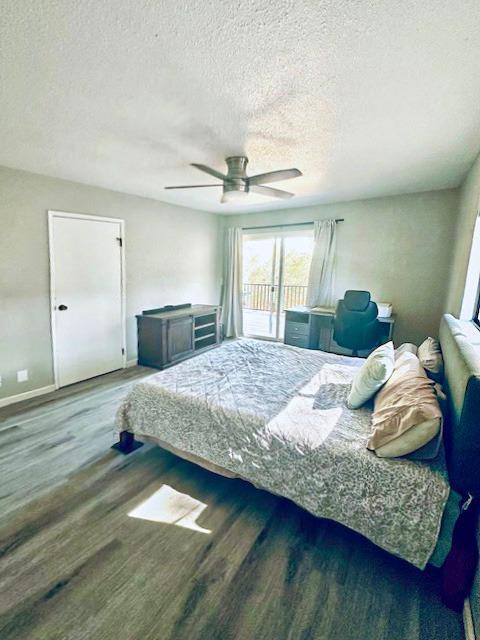 bedroom with hardwood / wood-style floors, access to exterior, a textured ceiling, and ceiling fan