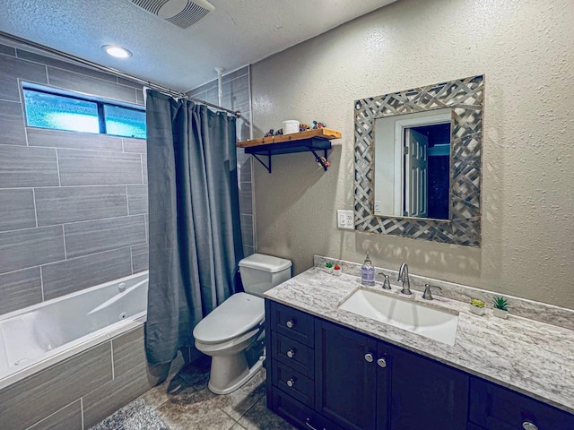 bathroom with visible vents, a textured wall, toilet, tiled shower / bath combo, and vanity