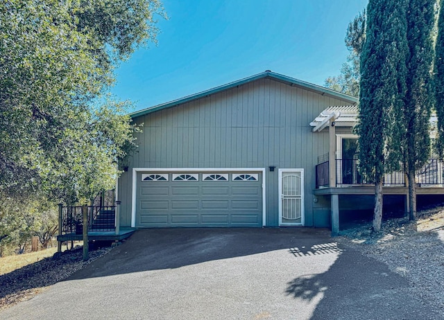 view of side of home with a wooden deck and a garage