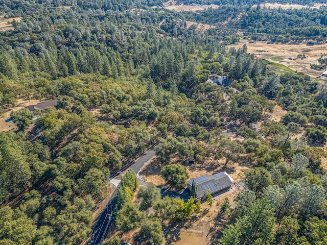 drone / aerial view featuring a wooded view