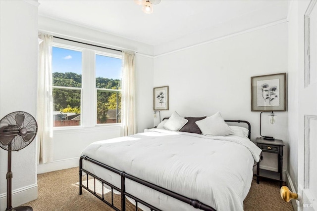 carpeted bedroom featuring baseboards