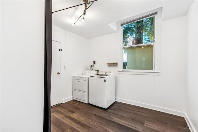 clothes washing area with laundry area, baseboards, separate washer and dryer, and dark wood finished floors