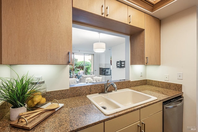 kitchen featuring dishwasher, light brown cabinets, decorative light fixtures, and sink